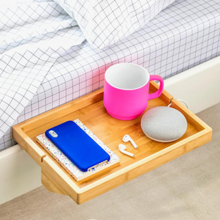 Wood shelf with phone, mug, and headphones attached to side of bed, dorm room cool finds