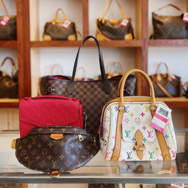 A collection of Louis Vuitton bags on a counter at Keeks in Plano